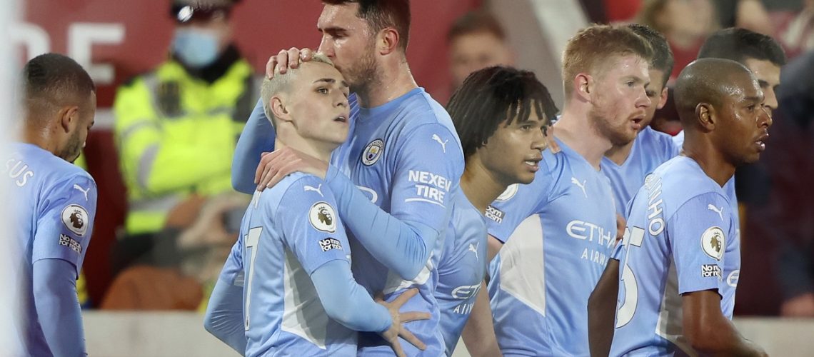 Manchester City's Phil Foden, second left, celebrates after scoring the opening goal during the English Premier League soccer match between Brentford and Manchester City at the Brentford Community Stadium in London, Wednesday, Dec. 29, 2021. (AP Photo/Ian Walton)