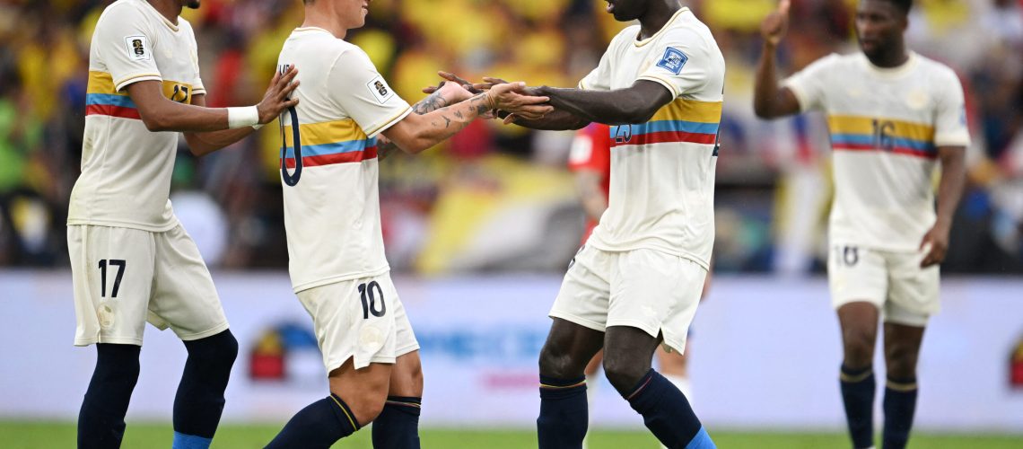 Colombia's defender #23 Davinson Sanchez (R) celebrates with teammates midfielder #10 James Rodriguez and defender #17 Johan Mojica after scoring a goal during the 2026 FIFA World Cup South American qualifiers football match between Colombia and Chile at the Roberto Melendez Metropolitan stadium in Barranquilla, Colombia, on October 15, 2024. (Photo by Raul ARBOLEDA / AFP)
