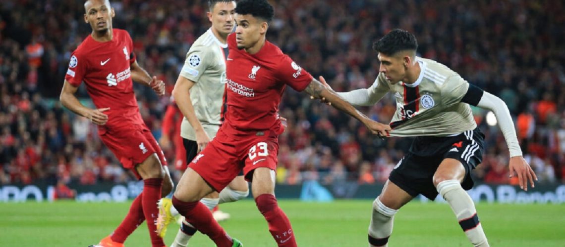 Liverpool's Colombian midfielder Luis Diaz (C) fights for the ball with Ajax's Mexican defender Edson Alvarez (R) during the UEFA Champions League group A football match between Liverpool and Ajax at Anfield in Liverpool, north west England on September 13, 2022. (Photo by Lindsey Parnaby / AFP)
