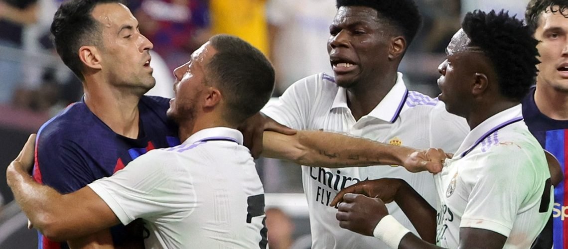 LAS VEGAS, NEVADA - JULY 23: (L-R) Sergio Busquets #5 of Barcelona scuffles with Eden Hazard #7, Aurélien Tchouaméni #18 and Vinícius Júnior #20 of Real Madrid during their preseason friendly match at Allegiant Stadium on July 23, 2022 in Las Vegas, Nevada. Barcelona defeated Real Madrid 1-0. (Photo by Ethan Miller/Getty Images)