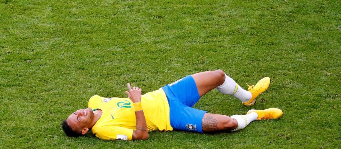 Soccer Football - World Cup - Round of 16 - Brazil vs Mexico - Samara Arena, Samara, Russia - July 2, 2018  Brazil's Neymar lies on the pitch after sustaining an injury   REUTERS/David Gray